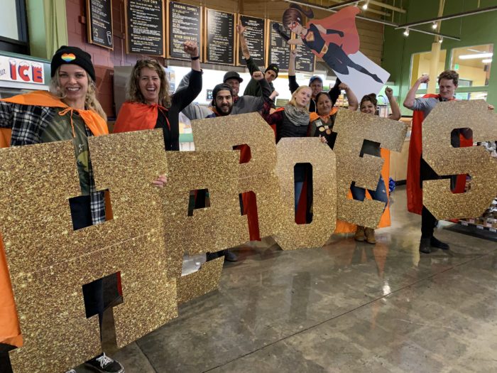 supporters holding letter signs that read HEROES