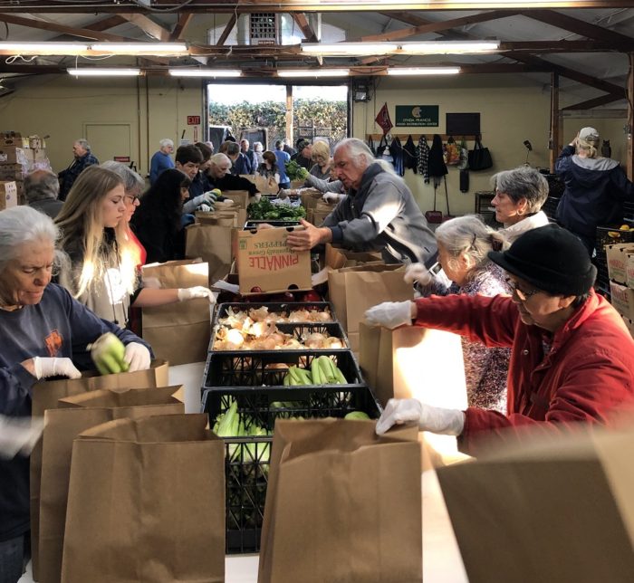 Volunteers sort and pack food