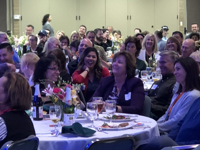 Group laughing at sit-down event