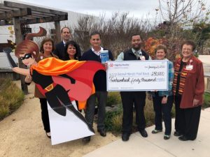 Dignity Health donating funds money during fundraising event