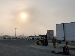 Loading boxes onto a tractor-trailer during mass distribution