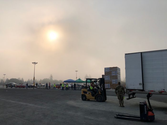 Loading boxes onto a tractor-trailer during mass distribution