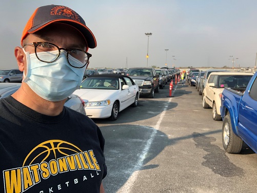 Volunteer in mask at mass food distribution center