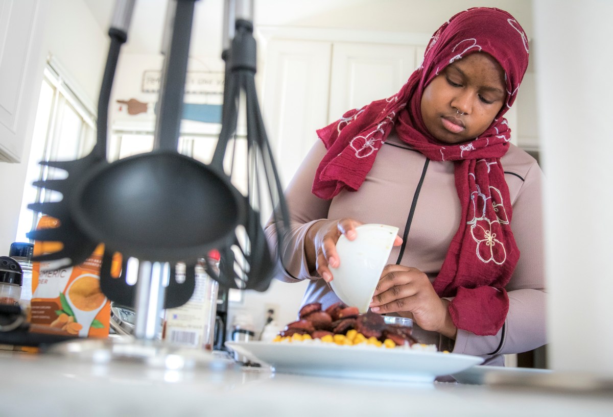 Woman in headscarf making a meal