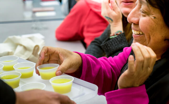 Woman taking sample of soup