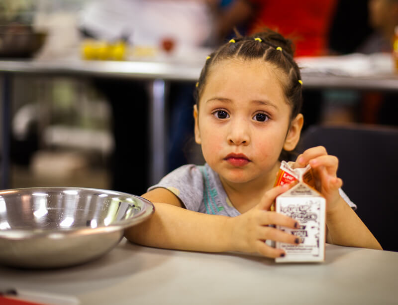 small girl drinking milk